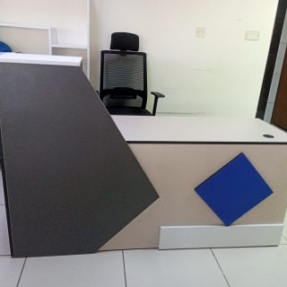 Executive reception desk 1800mm featuring modern geometric design with angular elements in premium corporate office reception area setting